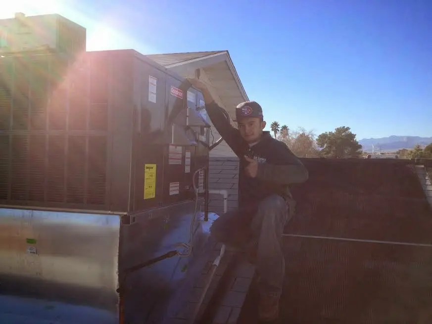 HVAC technician performing HVAC Inspection on a rooftop unit in Middle